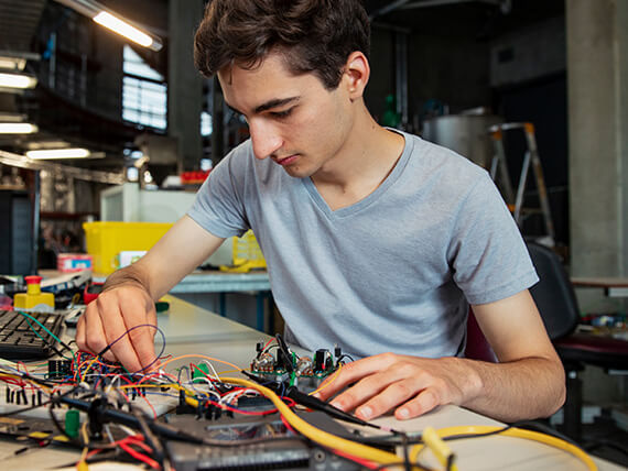 Young man working on a complex circuits