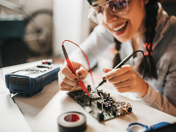 Young woman working on a circuit board